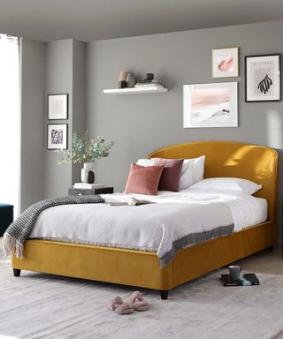 Mustard yellow velvet king size bed with storage by Danetti in a grey bedroom