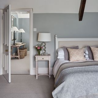 bedroom with grey wall with bedside table