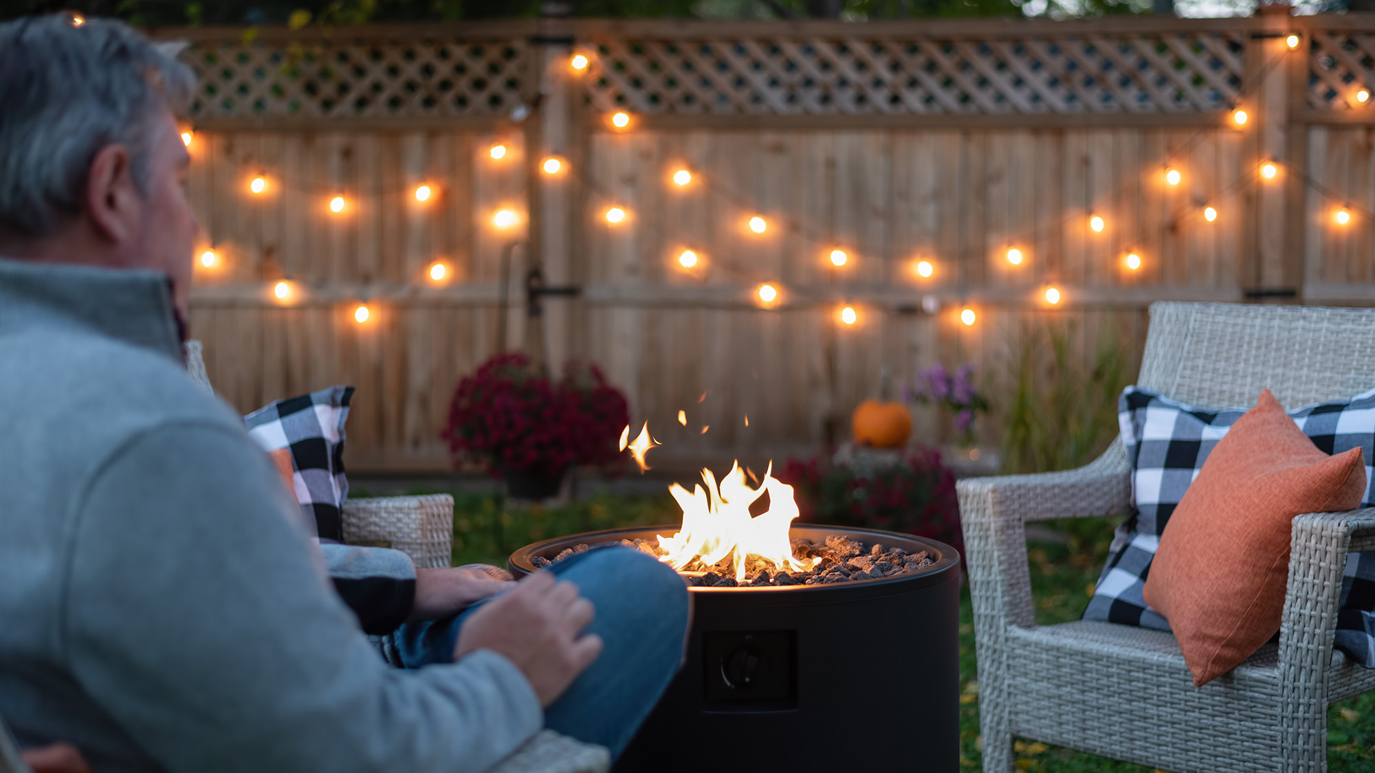 Man sitting besides fire pit