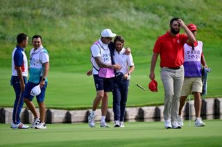 Jon Rahm walks off the green