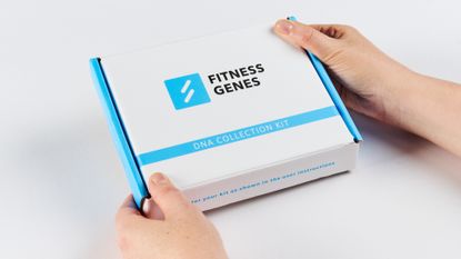 Female cyclist holding a Fitness Genes DNA collection kit
