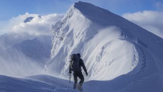 A climber on a snowy ridge