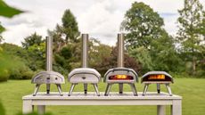 Four Ooni pizza ovens in a line