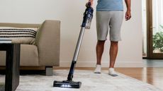 A Shark Pet Cordless Stick Vacuum on a carpet