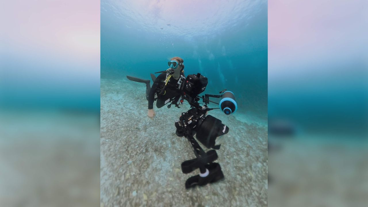 Emily Rhyne diving using a camera.