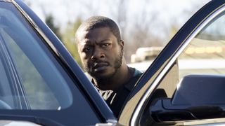 Edwin Hodge as Special Agent Ray Cannon getting into a vehicle in FBI: Most Wanted season 4