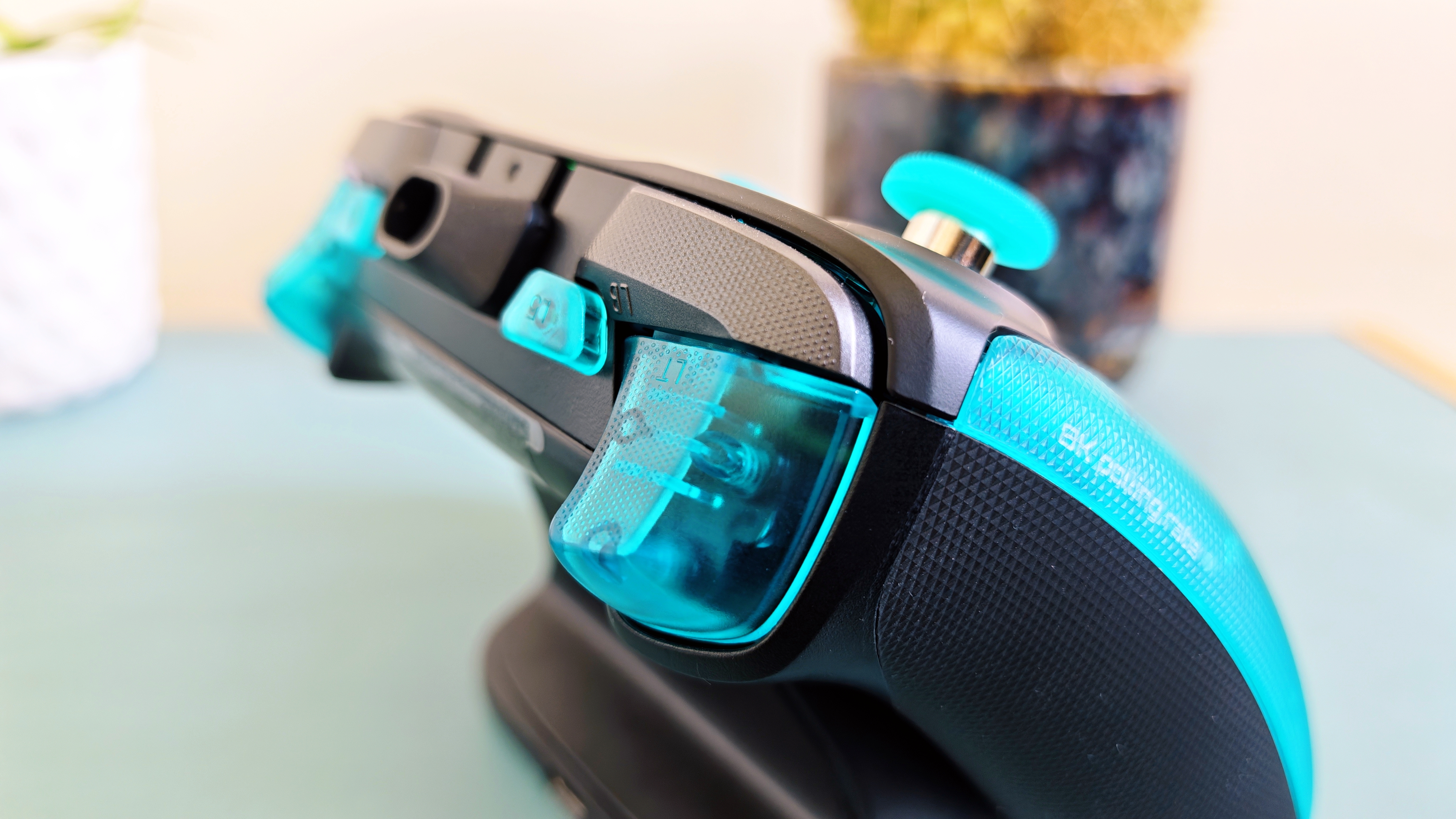A cyan GameSir G7 Pro 8K controller on a blue table