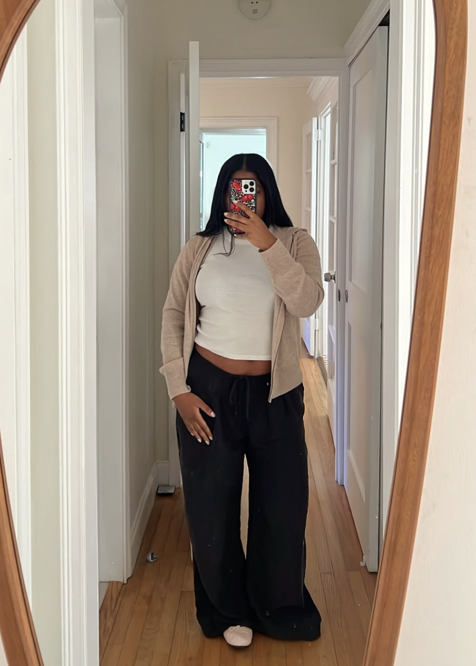 a woman wears a white T-shirt with black pants