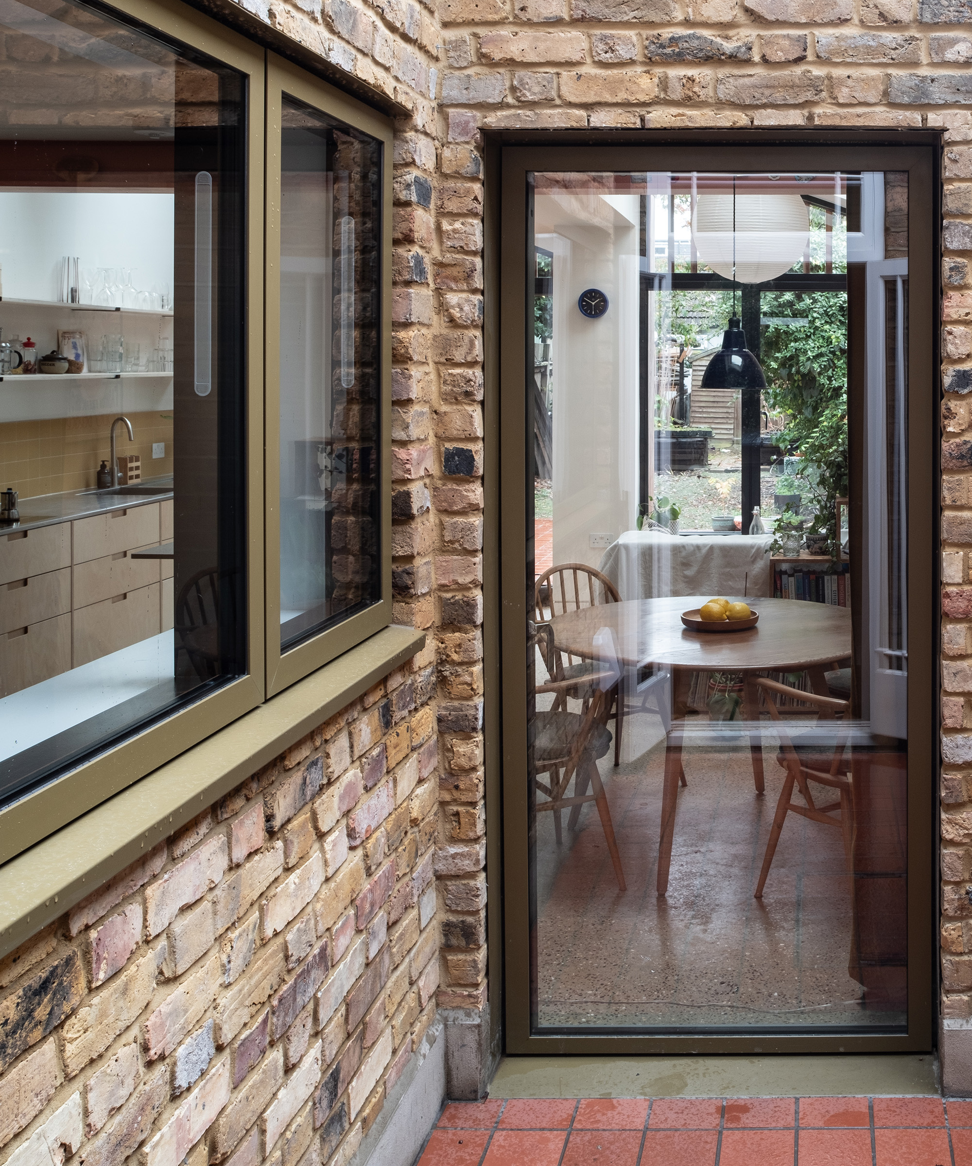 An interior courtyard in a ground floor rear extension project. The exterior walls are light brick and the floor is terracotta