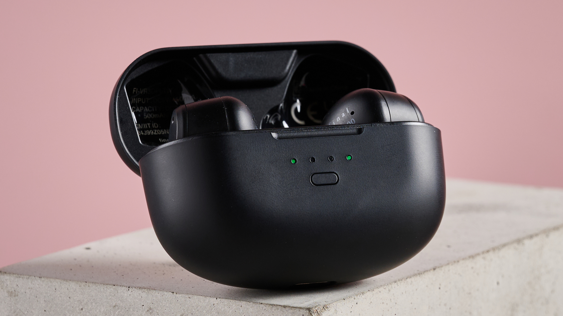 Final VR3000 Wireless earbuds in case with lid open, on plinth with pink background