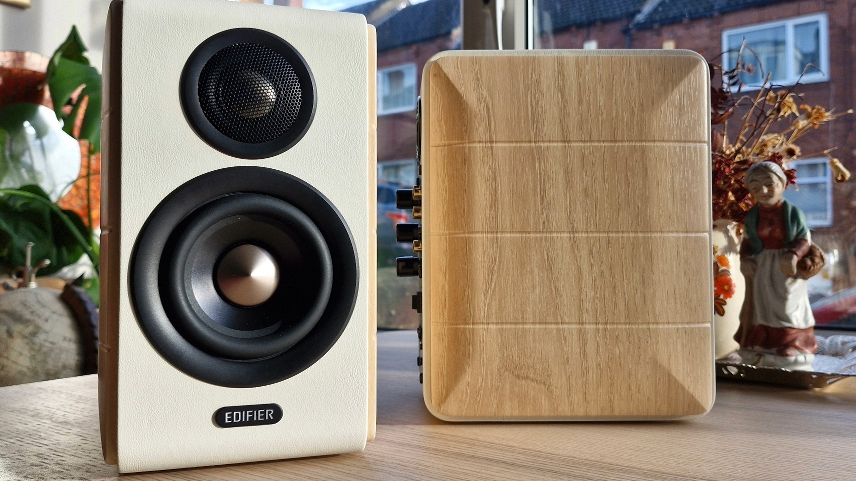 Front panel of one Edifier S880DB MKII active bookshelf speaker, with the other flipped 90 degrees to show the pine construction on the side.