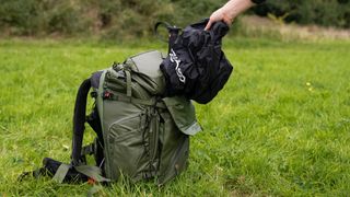 The rain cover being removed from the PGYTech OnePro Focux Backpack