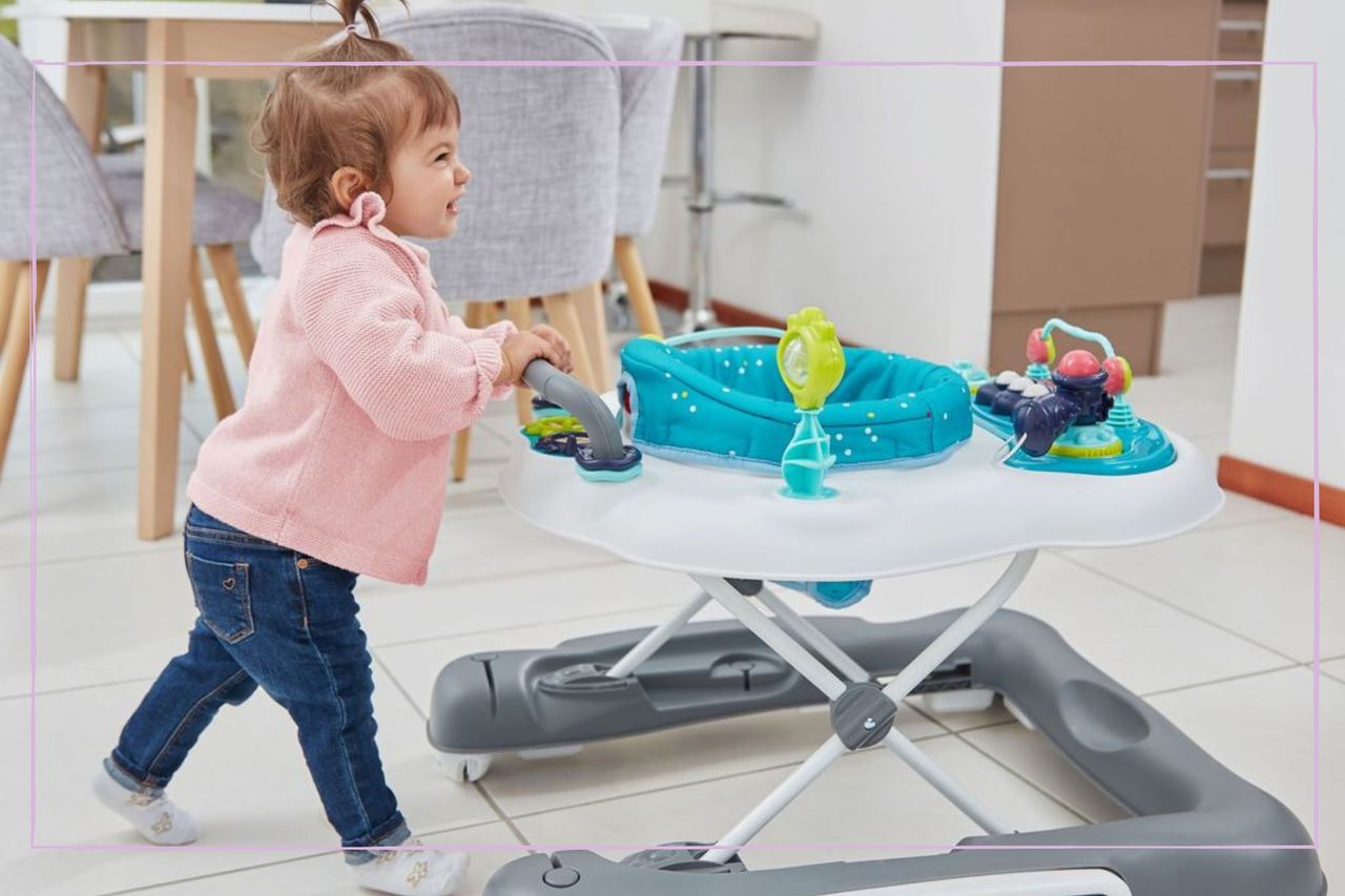 Toddler pushing the Babymoov 5-in-1 Progressive Walker at home