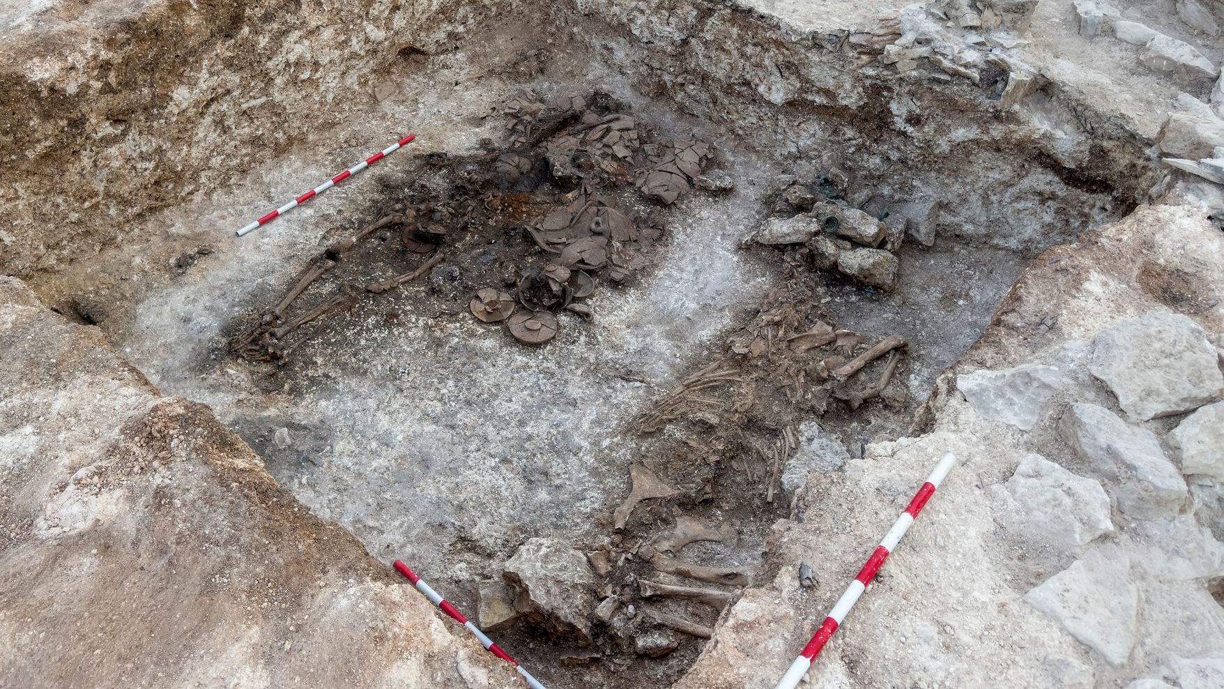 two burials in the ground, including a man and a horse