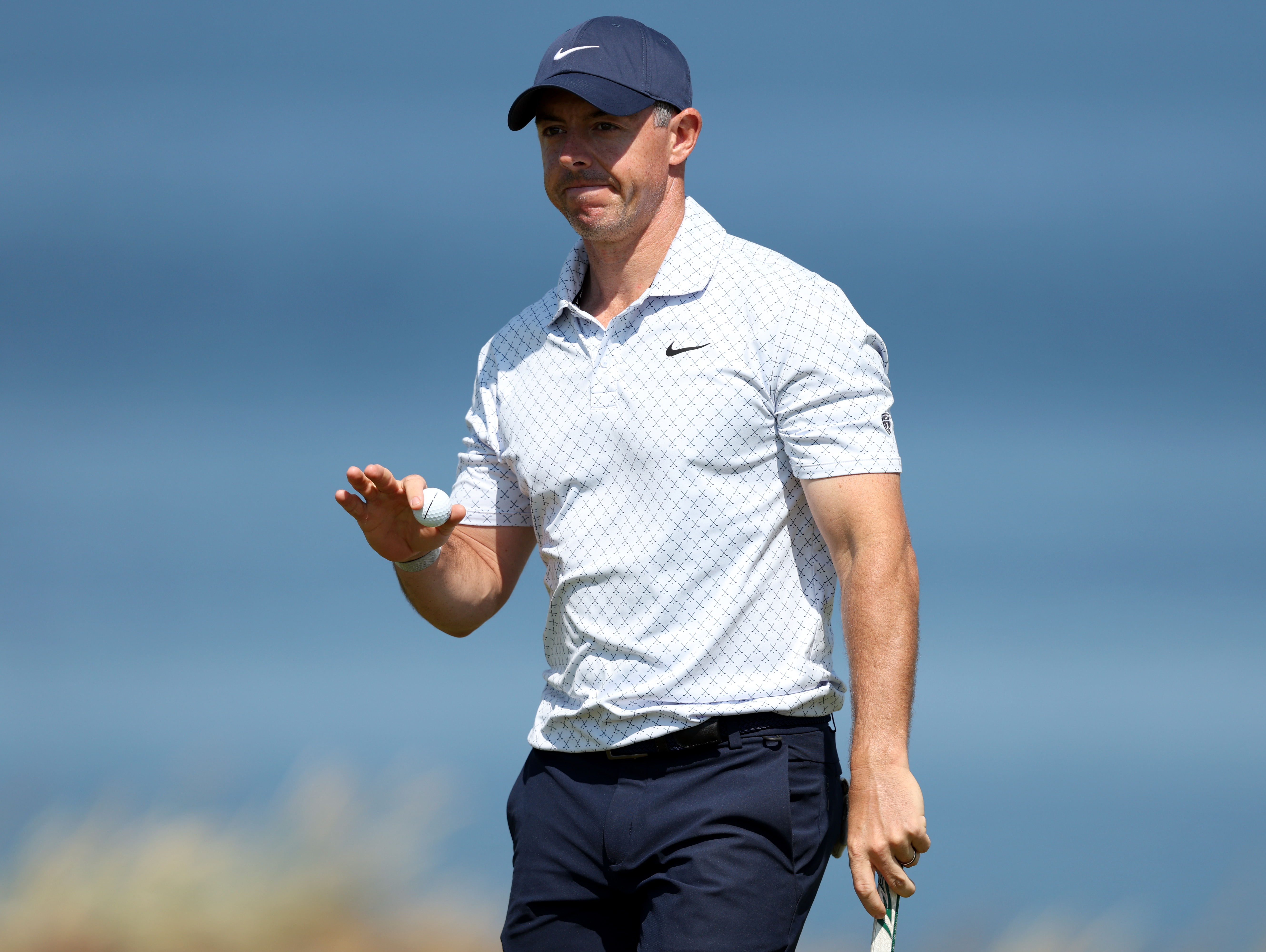 Rory McIlroy of Northern Ireland acknowledges the crowd on the fifth green on day one of the Genesis Scottish Open 2026 at The Renaissance Club on July 09, 2026 (Photo by Sean M. Haffey/Getty Images)