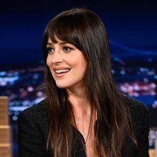 Dakota Johnson wears a low-cut blazer
