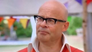 Harry Hill wears glasses and talks on Great British Bake Off.
