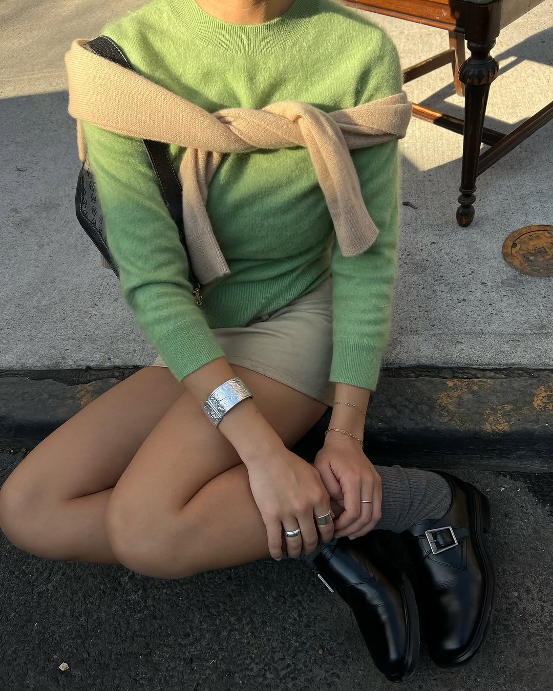 Woman wearing a sweater styling idea for 2025 in summer.