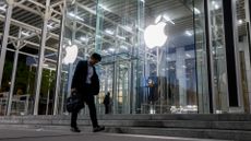 Man walks outside Apple Store in New York (Fifth Avenue)