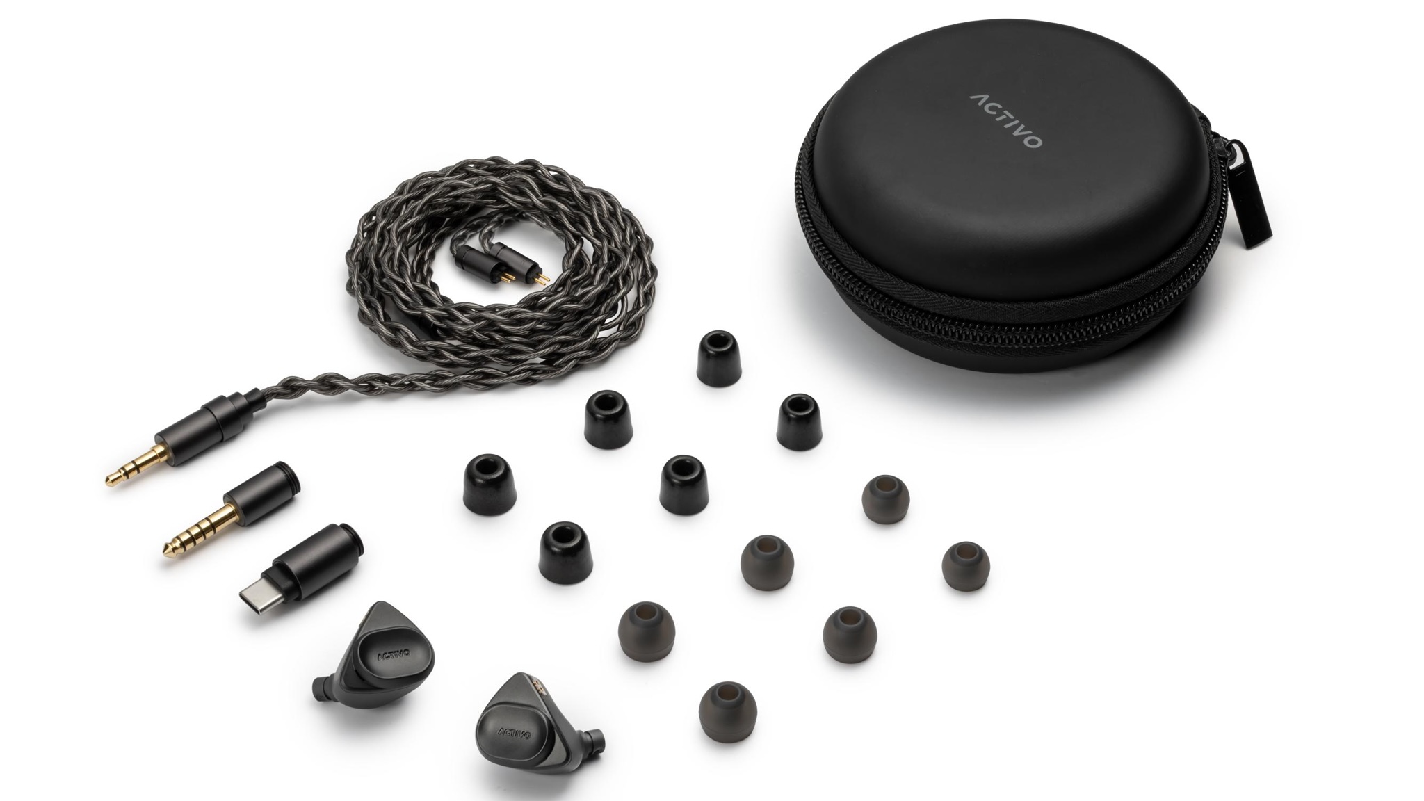 Product photography of the Activo Volcano earphones, tips, cable and case in black