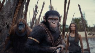 Noa protects Mae on a wooden bridge in Kingdom of the Planet of the Apes, one of May's new movies