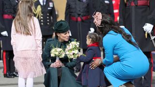 Catherine, Duchess of Cambridge with 20-month-old Gaia Money and her mother Lorraine Money, as she attends the 1st Battalion Irish Guards' St. Patrick's Day Parade with Prince William, Duke of Cambridge at Mons Barracks on March 17, 2022 in Aldershot, England.
