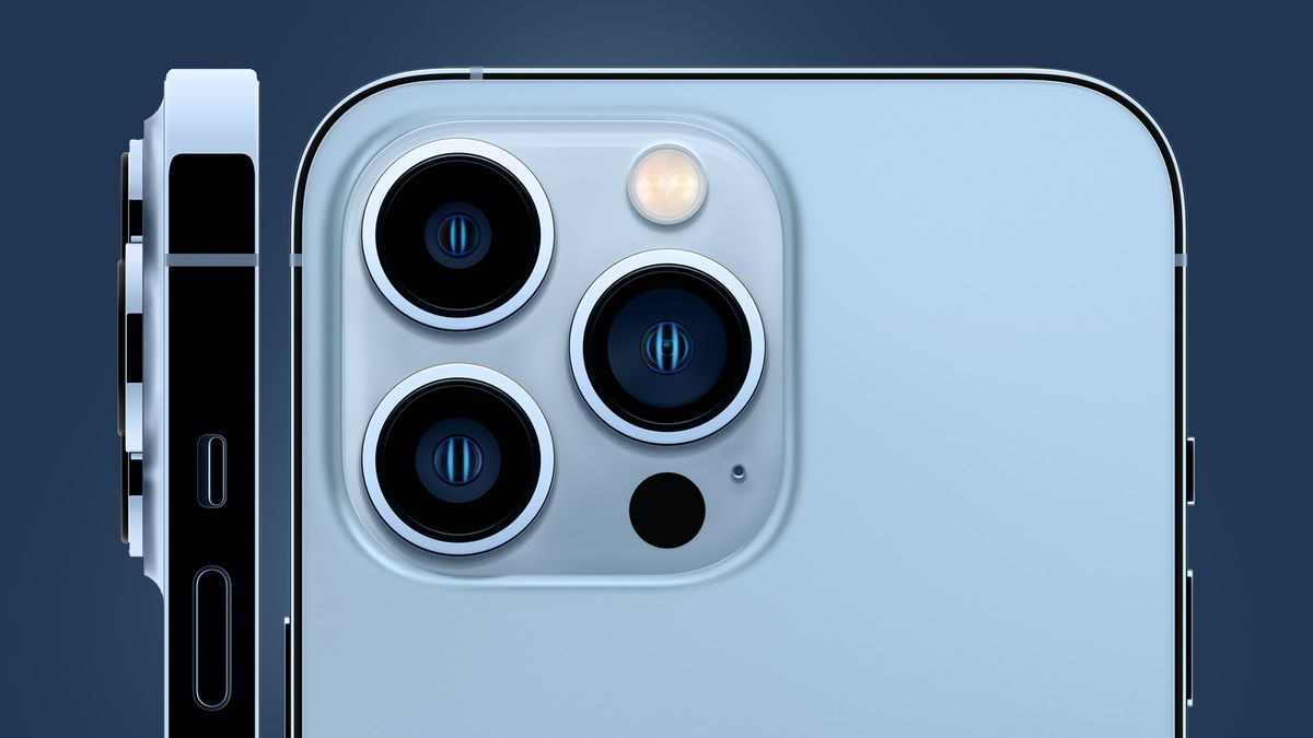 The iPhone 13 Pro&#039;s camera module on a blue background