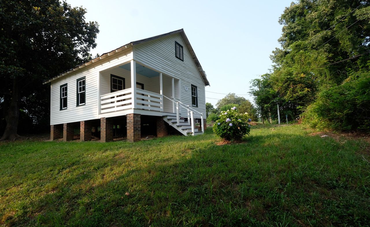 white house on green grass at Nina Simone childhood home in Tryon, North Carolina