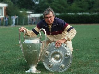 Ernst Happel poses with the European Cup and Bundesliga trophies at Hamburg in 1983.