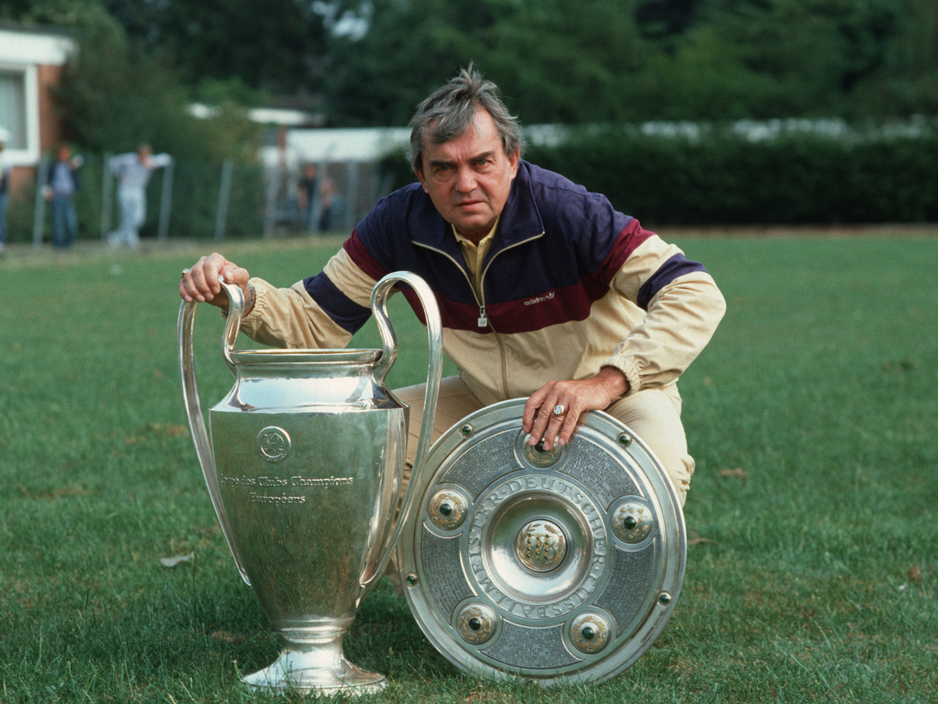 Ernst Happel poses with the European Cup and Bundesliga trophies at Hamburg in 1983.