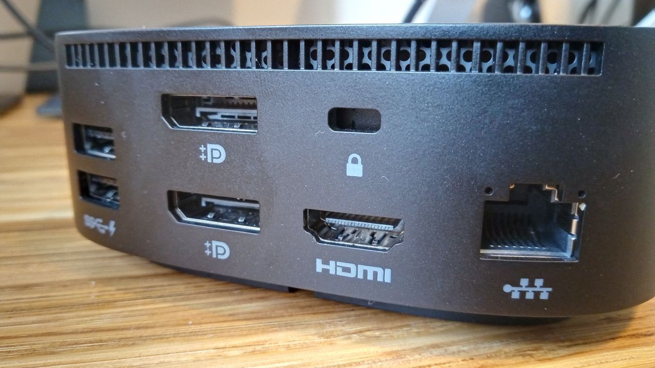 A black HP USB-C Dock G5 sitting on a wooden table