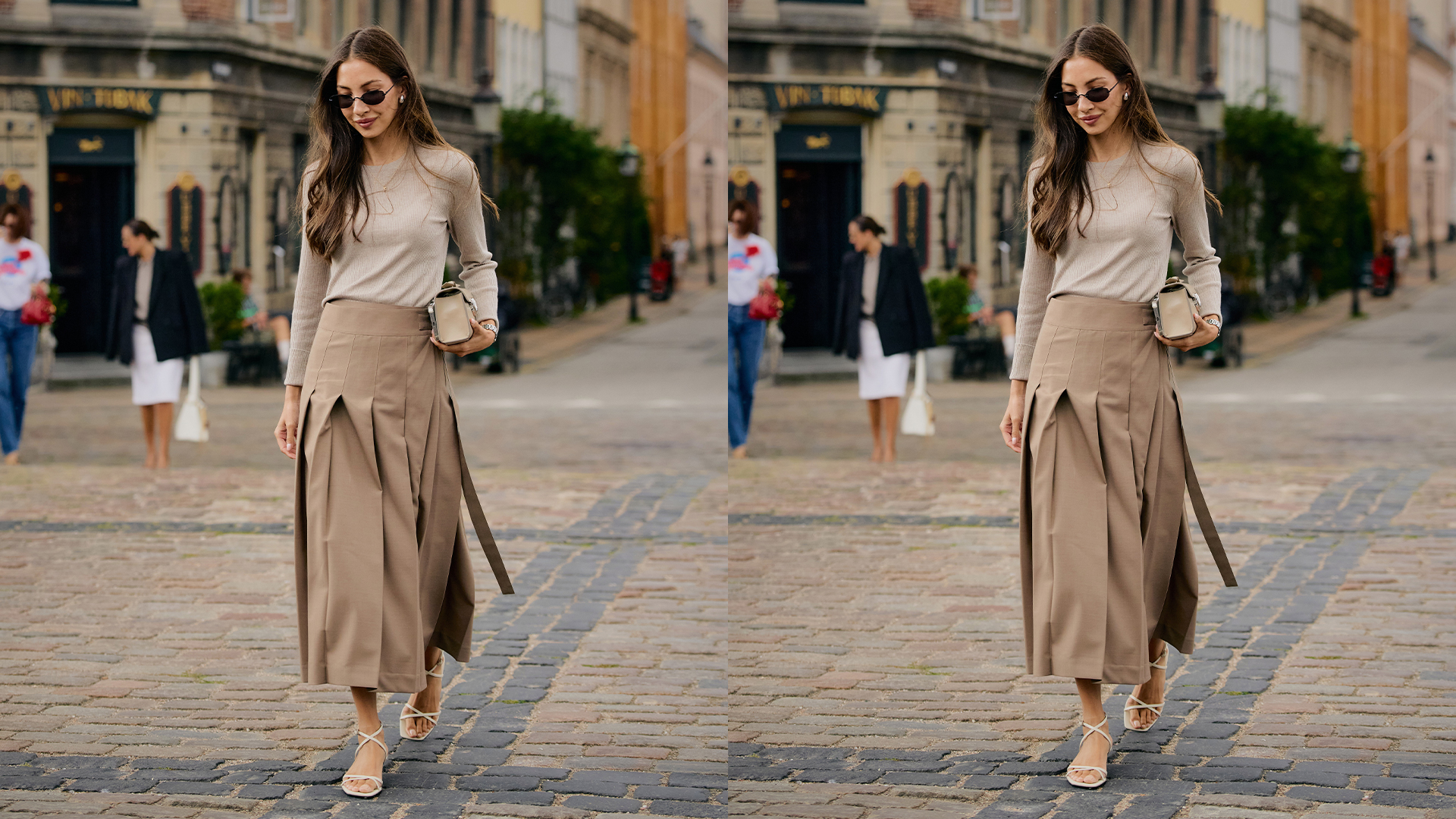 Woman wears pleated skirt, longsleeve top, and heeled sandals. 