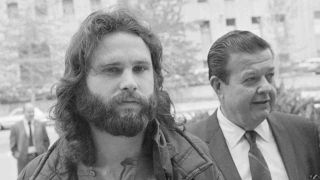 The Doors singer Jim Morrison arriving at court in Los Angeles in 1969 accompanied by his lawyer