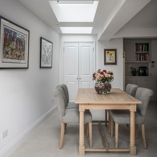 dining room with white walls and tiled flooring