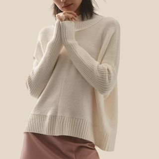 flat lay image of white knitted jumper