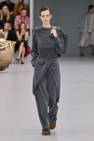 Loewe model wearing a gray sweater and pants on the SS24 show.