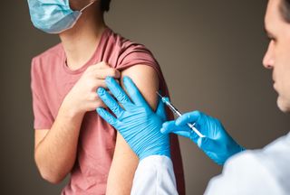 a teenager receiving a vaccination. 