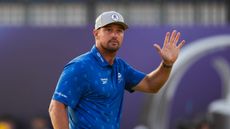 Bryson DeChambeau waves to fans during round two of The Open at Royal Birkdale