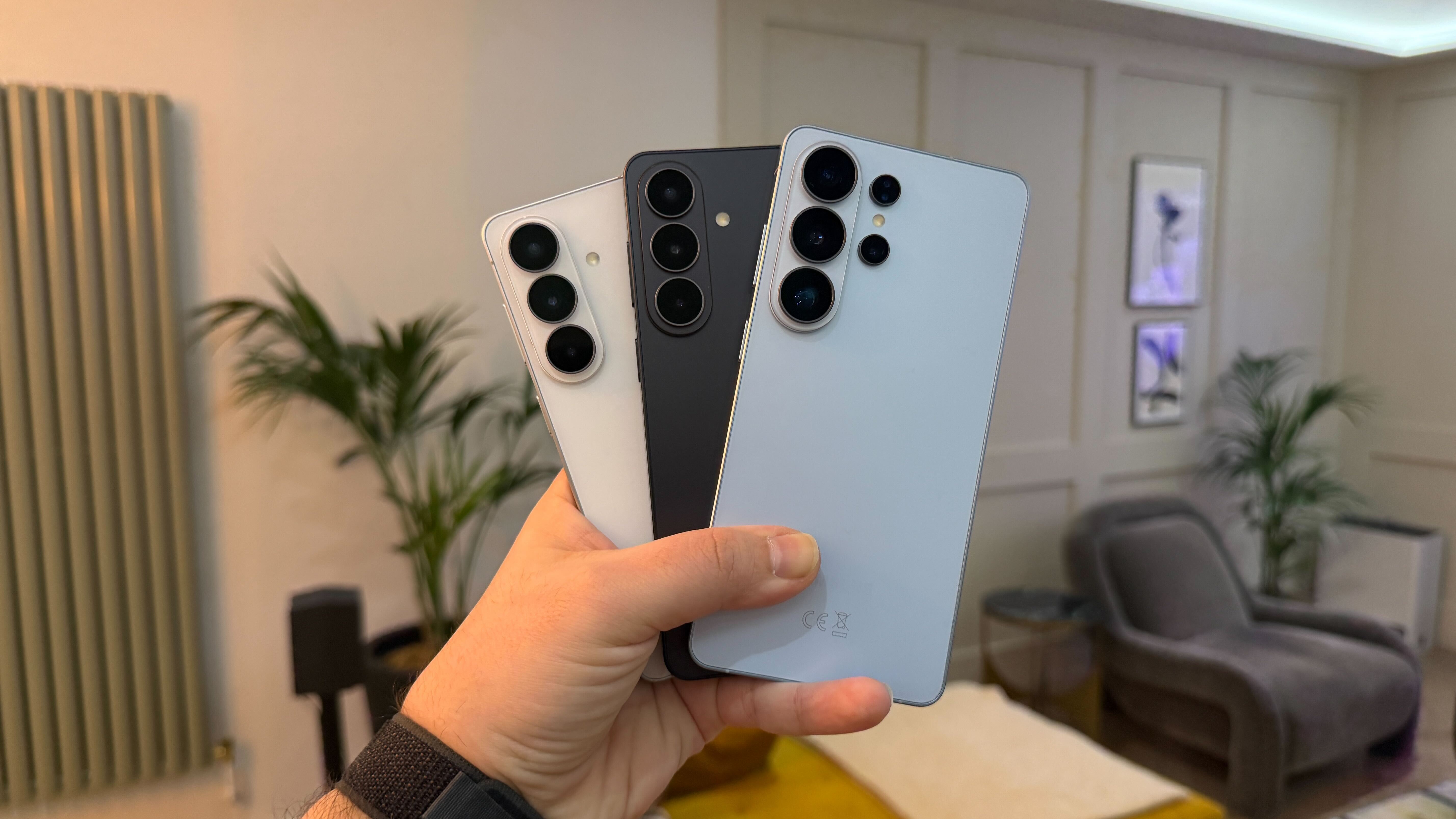 The Samsung Galaxy S26 range being held in a modern living space