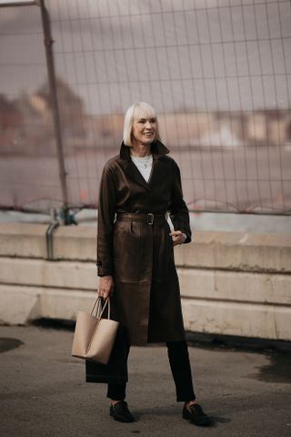 Woman at Fashion Week walking in the street wearing loafers,