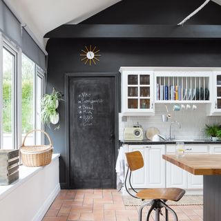 kitchen with chalkboard wall and cream dresser unit