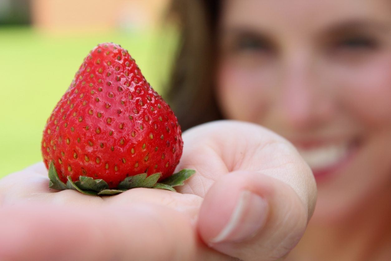 Woman&amp;#39;s Hand Holding Red Strawberry