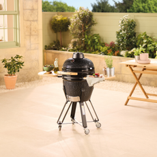 Aldi Kamado BBQ on a sand coloured patio.
