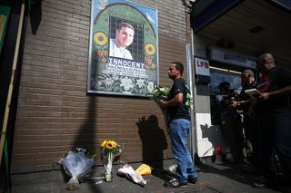 A well wisher pays tribute to Jean Charles de Menezes at a memorial near Stockwell tube station in London..