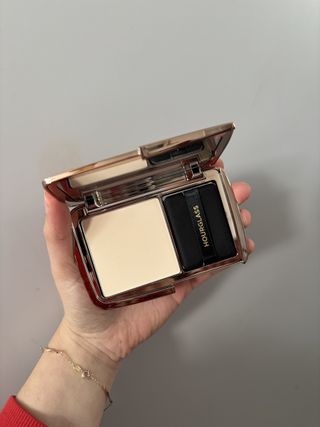 Mica Ricketts holding Hourglass Vanish Airbrushed Pressed Powder