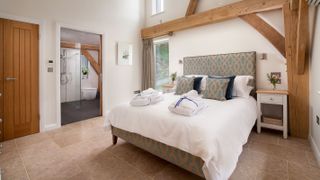 master bedroom suite with vaulted ceiling and en suite shower room