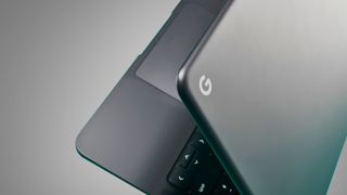 A Google Chromebook on a grey background