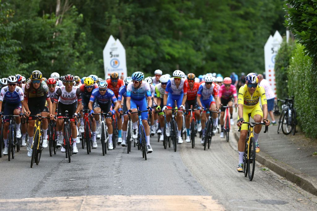 LONGWY FRANCE JULY 07 Wout Van Aert of Belgium and Team Jumbo Visma Yellow Leader Jersey caught by the peloton during the 109th Tour de France 2022 Stage 6 a 2199km stage from Binche to Longwy 377m TDF2022 WorldTour on July 07 2022 in Longwy France Photo by Michael SteeleGetty Images