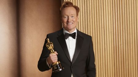 Conan O'Brien poses alongside an Oscar statuette for the 98th Academy Awards.