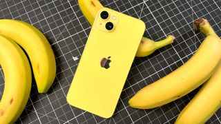 Yellow iPhone 14 Plus with bananas